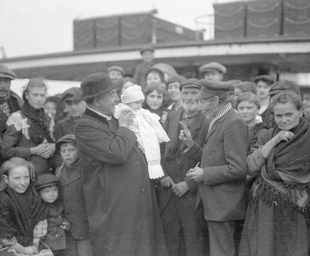 Father Merckx seen here with one of the youngest of the 300 Belgian refugees aboard a cross channel ferry bringing them to Great Britain 27th September 1914.
