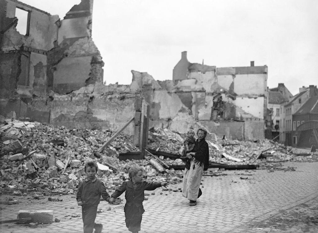 Refugees scurry through the ruins of the Belgian town of Termonde. September 09, 1914