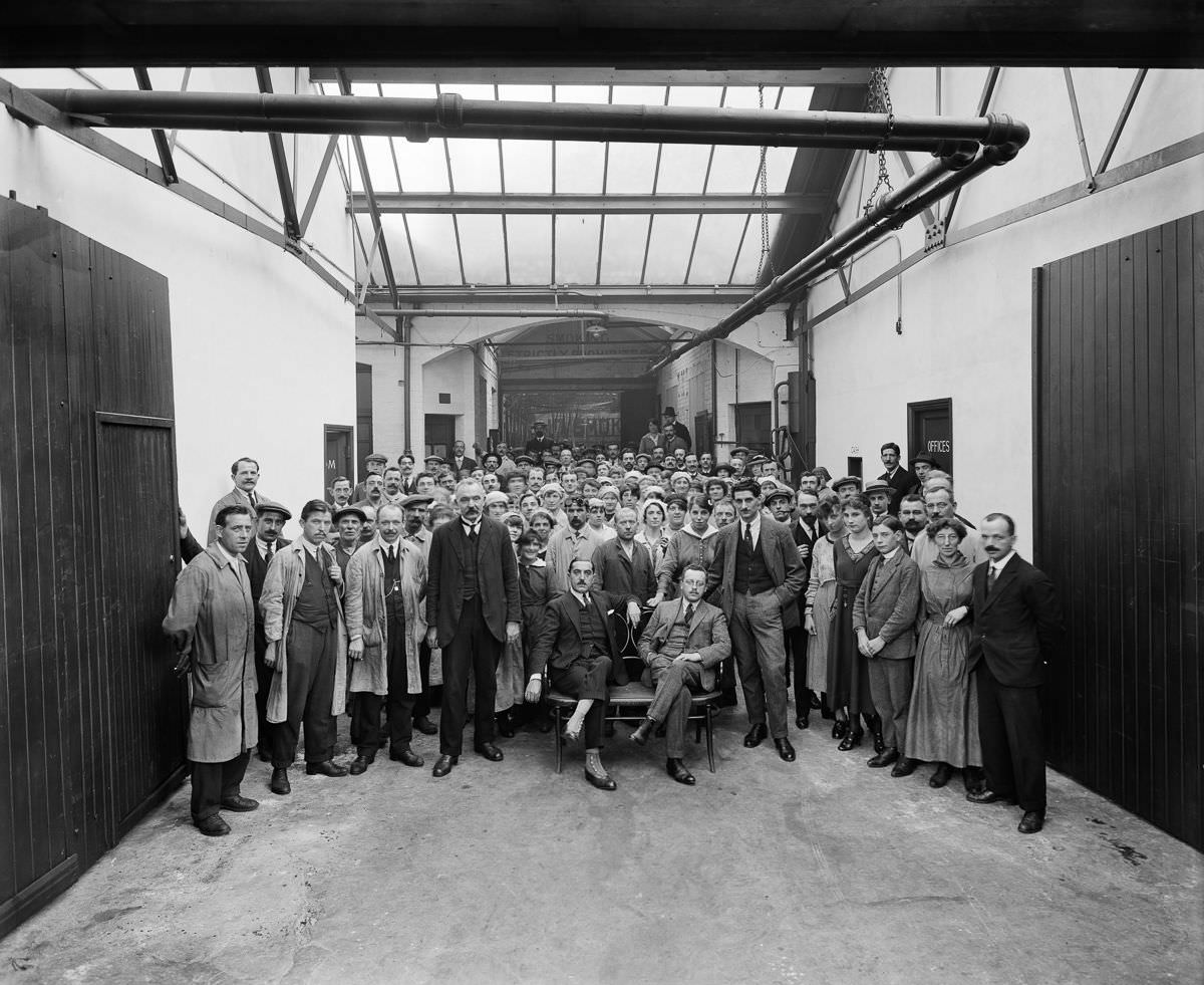 A group portrait of the managers and workers in the Belgian Munition Works in London, which employed Belgian refugees to manufacture grenades and artillery shells for the war effort, September 1918.