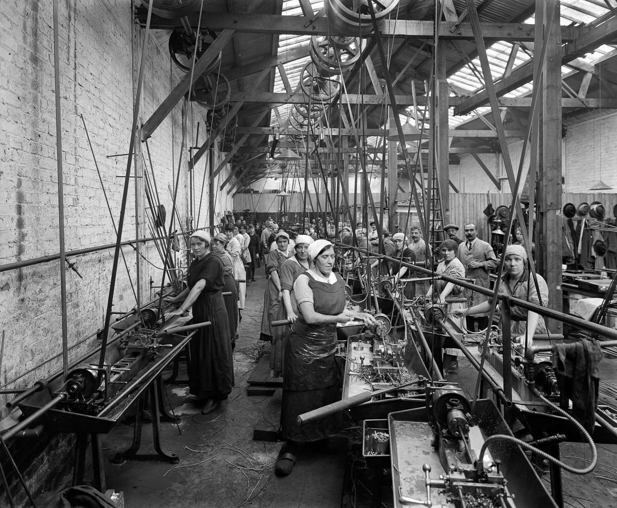 Belgian refugee women use lathes to make ammunition casings at the Belgian Munition Works in London, September 1918.