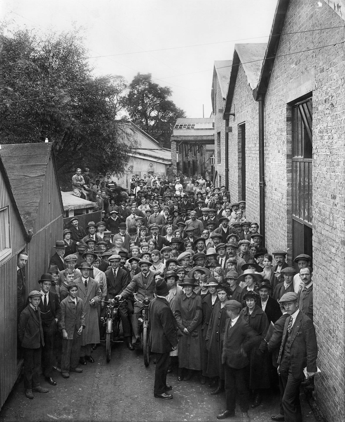 Belgian refugees outside the Belgian Munition Works in London, where they were employed to manufacture explosives for the war effort, September 1918.
