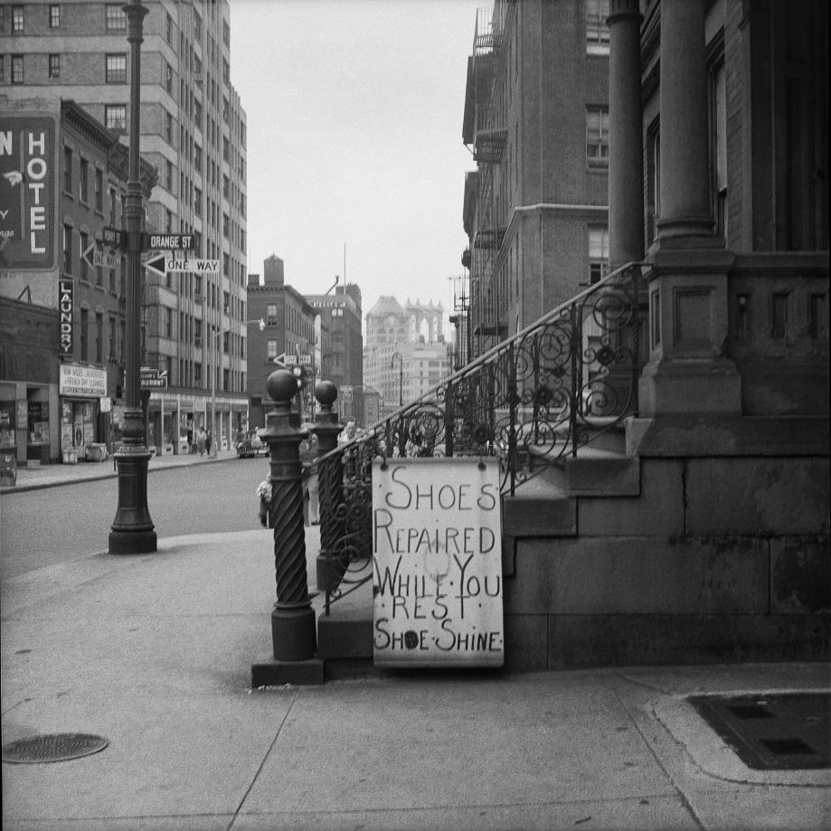 A shoe shine and repair sign on the corner of Orange and Henry Streets in Brooklyn Heights, March 1958.