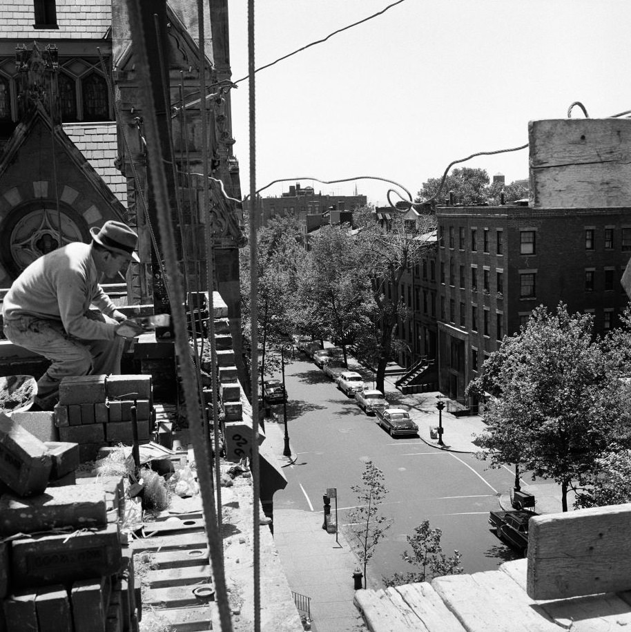 A construction worker takes a cigarette break on a building-in-progress in Brooklyn Heights, March 1958.