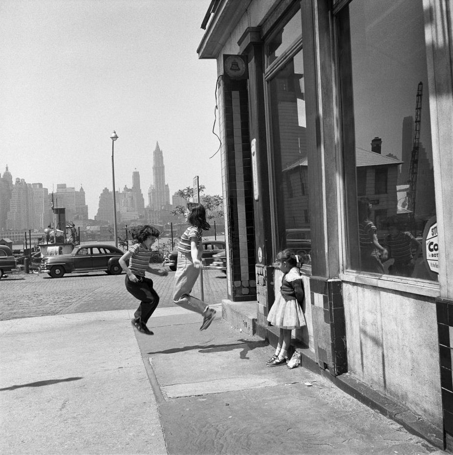Girls jump and play on Atlantic Avenue in Brooklyn Heights, March 1958.