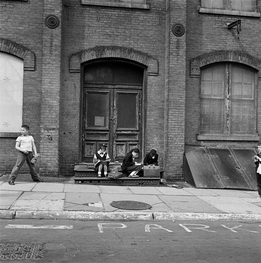 An ethnically diverse group of school children do their homework in Brooklyn Heights, March 1958.