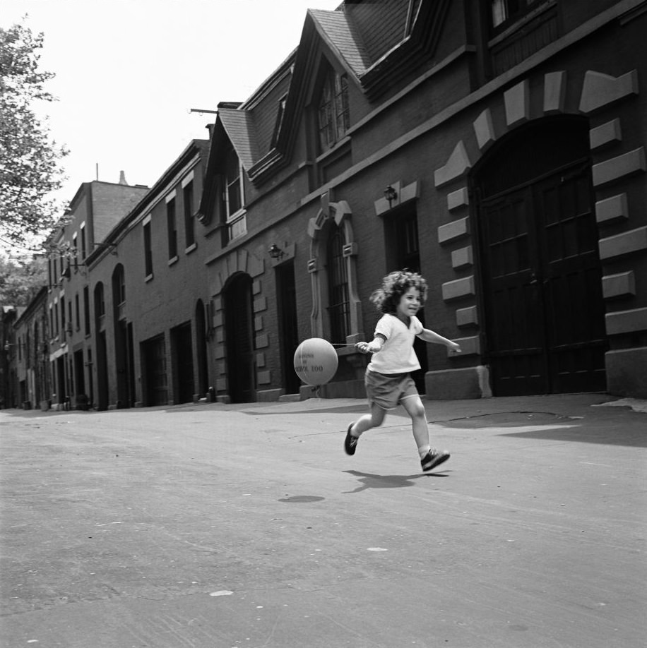 A young girl runs with a balloon on Love Lane in Brooklyn Heights, March 1958.