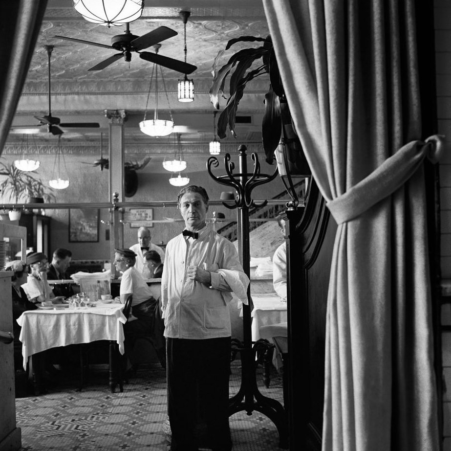 Waiters and diners during lunch at Joe's Restaurant, on Fulton Street in Brooklyn Heights, March 1958.