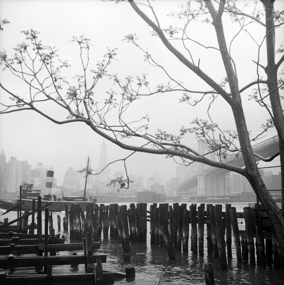 A view of the Brooklyn Bridge and the Manhattan skyline from the waterfront in Brooklyn Heights, March 1958.