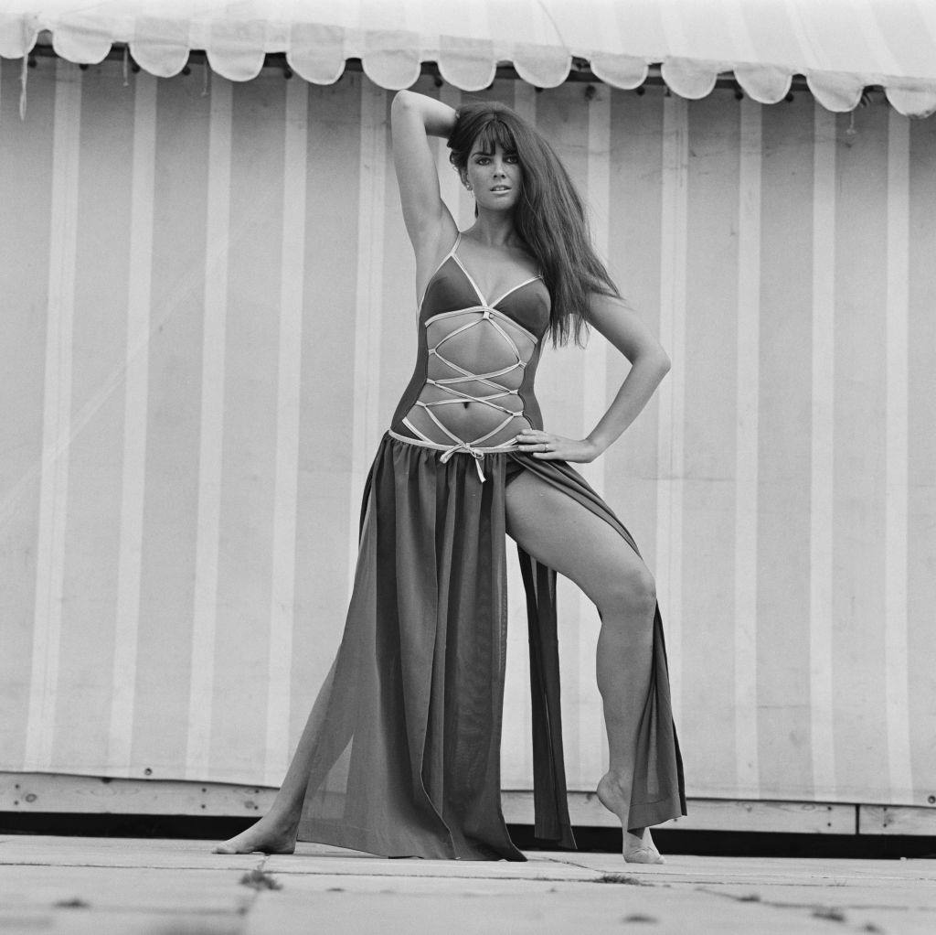 Caroline Munro in a swimsuit with a hipster skirt on 5th October 1970.