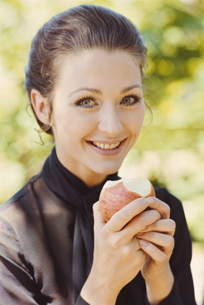 Christine Kaufmann pictured eating an apple in 1969.