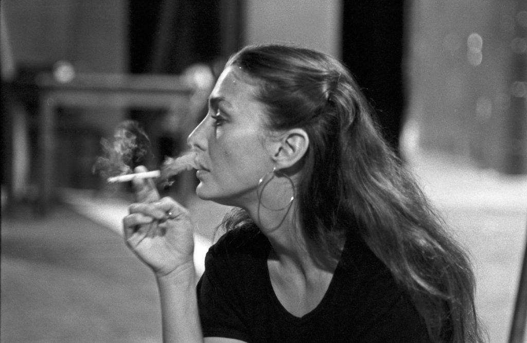 Christine Kaufmann smokes a cigarette during the break at theater rehearsals, 1970s.