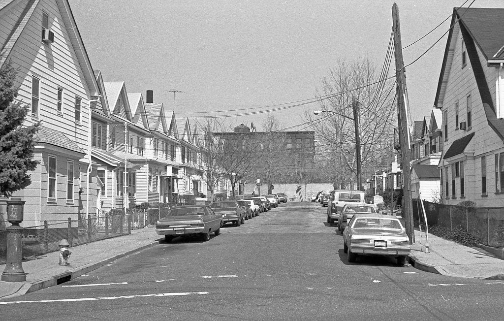 Looking north along 97th Place, of a line of residential homes, in the Corona neighborhood. Queens, New York, 1990.