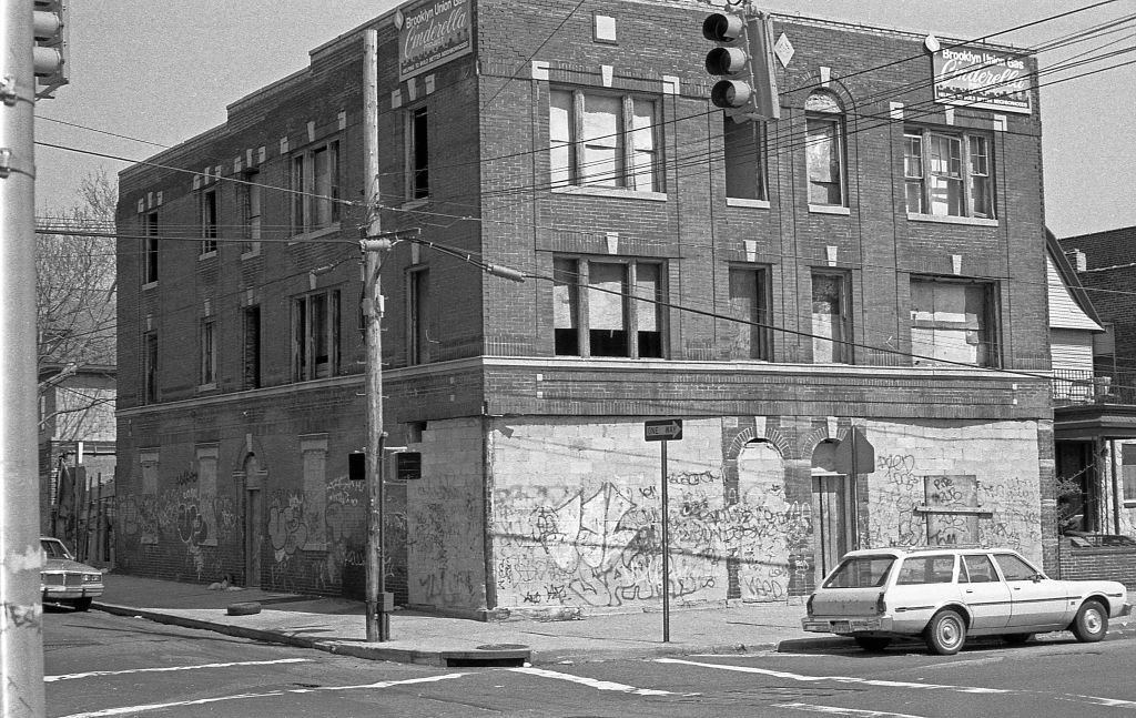 A graffiti-covered, abandoned building at the intersection of 108th Street and 36th Avenue. Queens, New York, 1990.