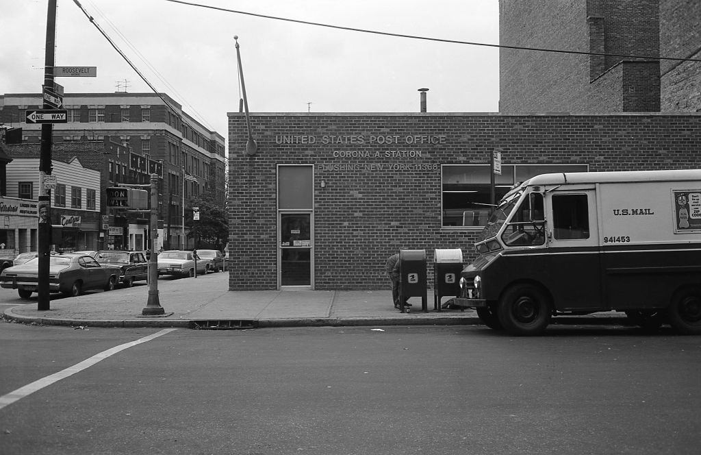 A US Mail truck sits parked in front of the Corona, NY Post Office at the corner of Roosevelt Avenue and 104th Street, 1974.