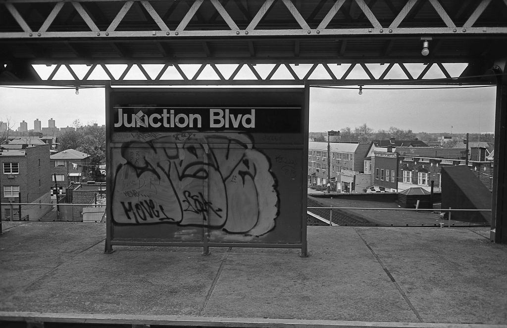 Graffiti covers the Junction Boulevard subway sign on the elevated line in Corona. 5th November 1974