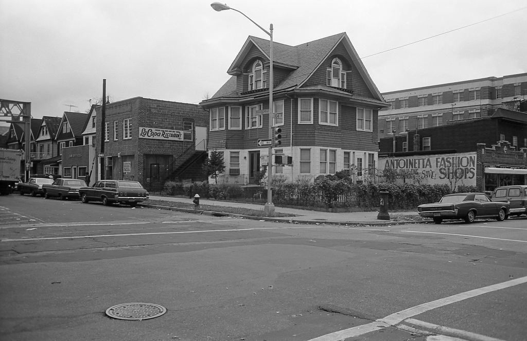Residential buildings and commercial businesses at the corner of 104th Street and Roosevelt Avenue in the heart of Corona, Queens, 1974.