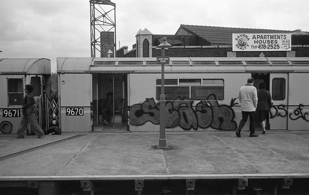 Commuters board a graffiti covered subway car at the Junction Boulevard station in Corona, Queens, 1974.