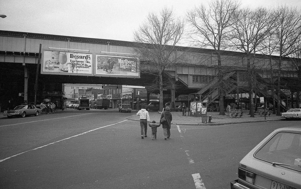 Intersection of National Street and Roosevelt Avenue near an elevated subway line in Corona. Queens, New York, 1982.