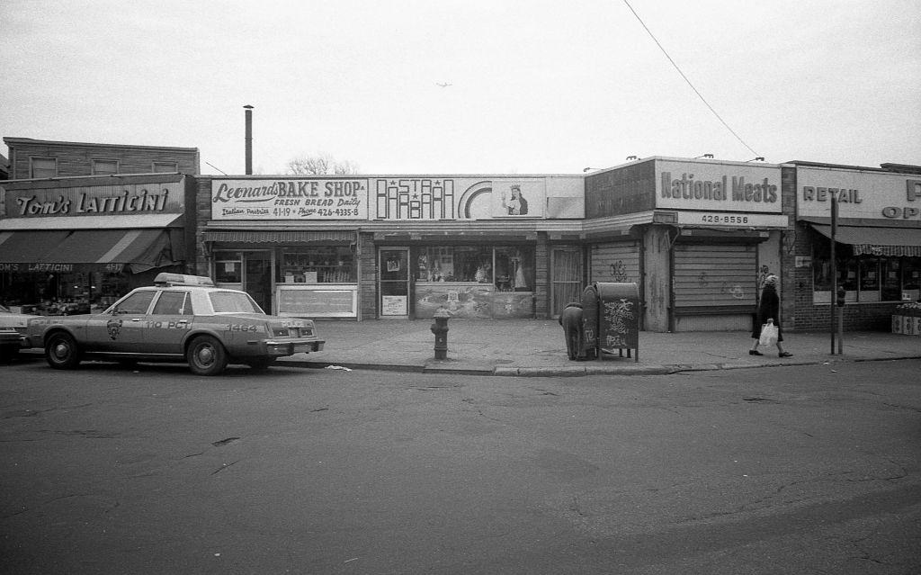 Veteran's Square park (at the intersection of 102nd and National streets), of various local businesses along 102nd Street, in the Corona. Queens, New York, 1982.