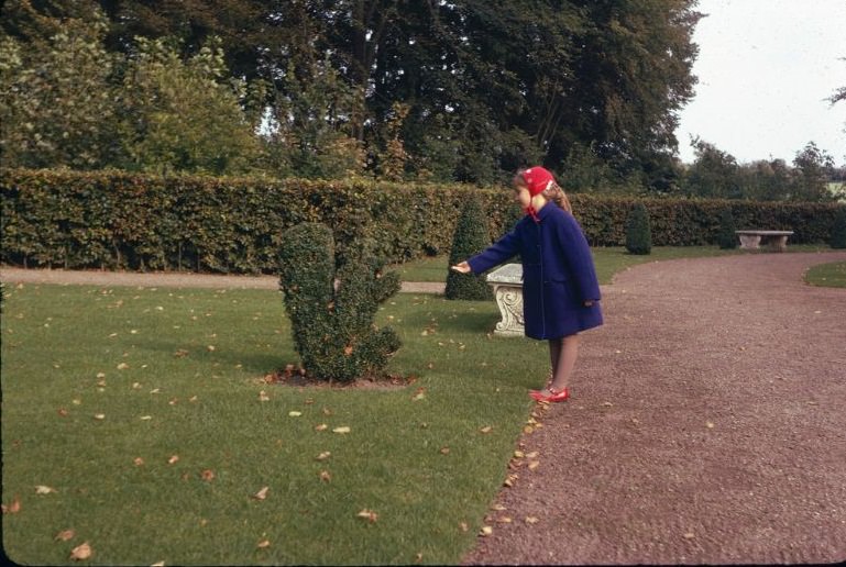 Girl and a topiary squirrel in the renaissance garden at Egeskov Castle, Funen Island, Denmark