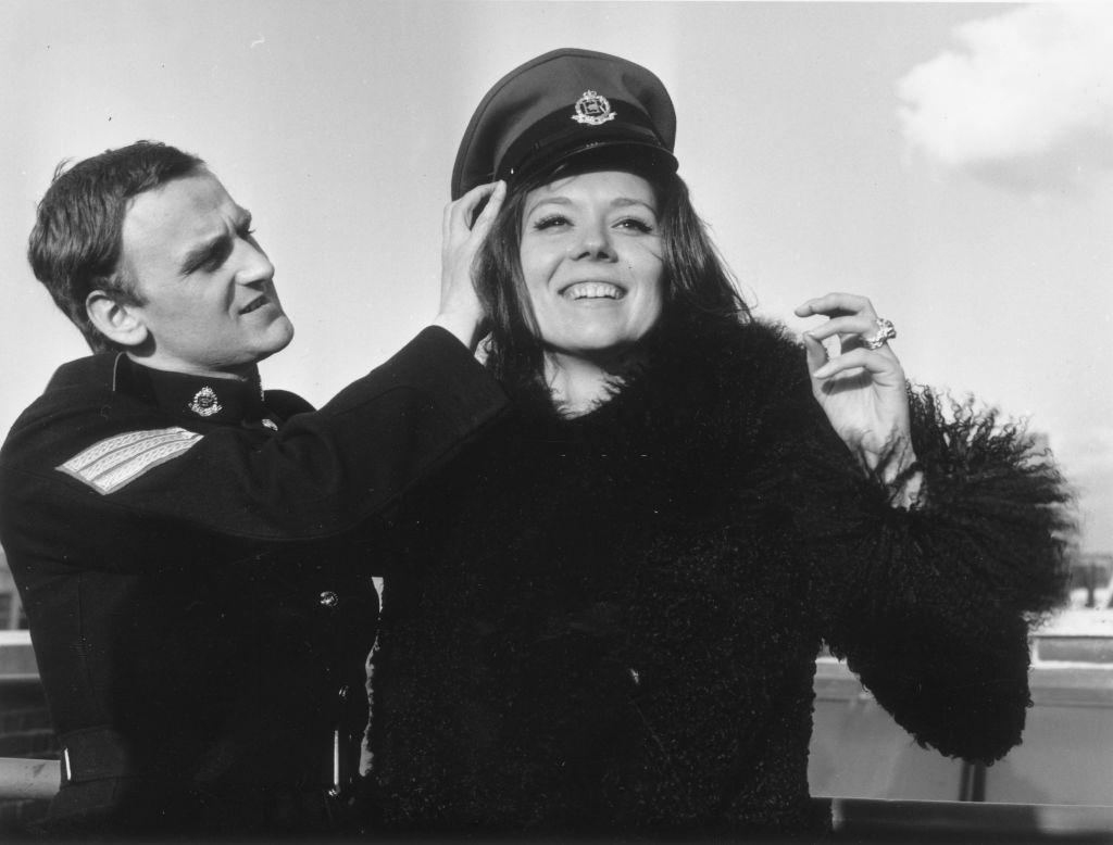 Diana Rigg trying John Thaw's hat on in Hanover Square, London, 1966.
