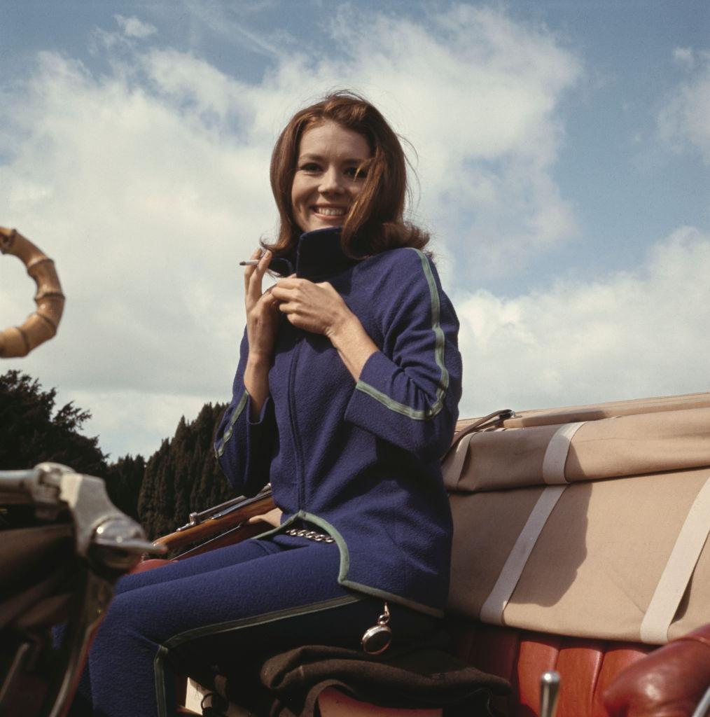 Diana Rigg in a blue tracksuit with green trim, 1964.