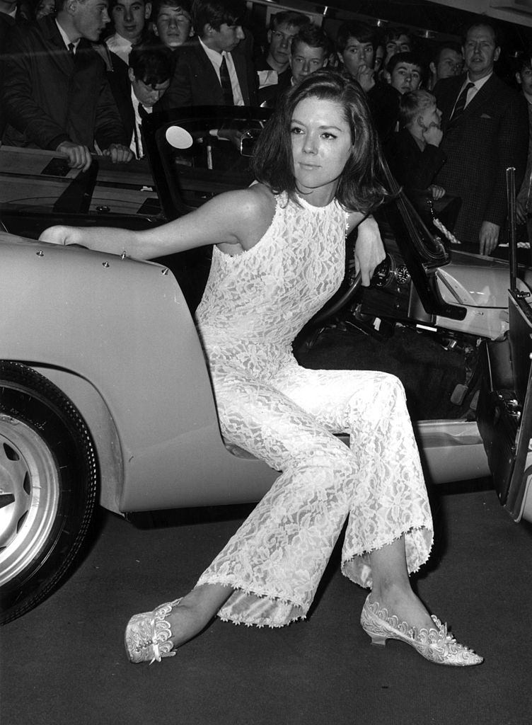 Diana Rigg trying out a car at The Motor Show, 1965.