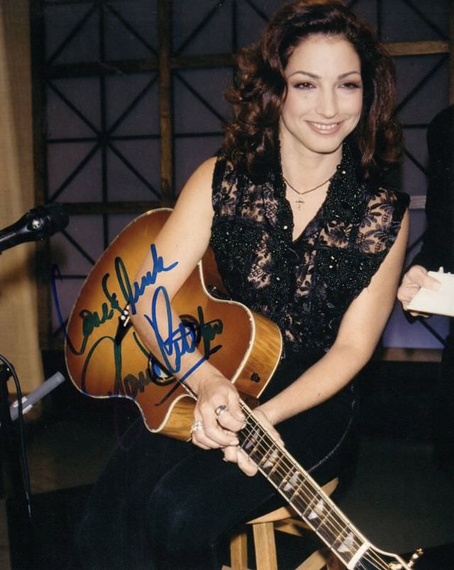 Gloria Estefan holding a guitar during a recording session, 1986.