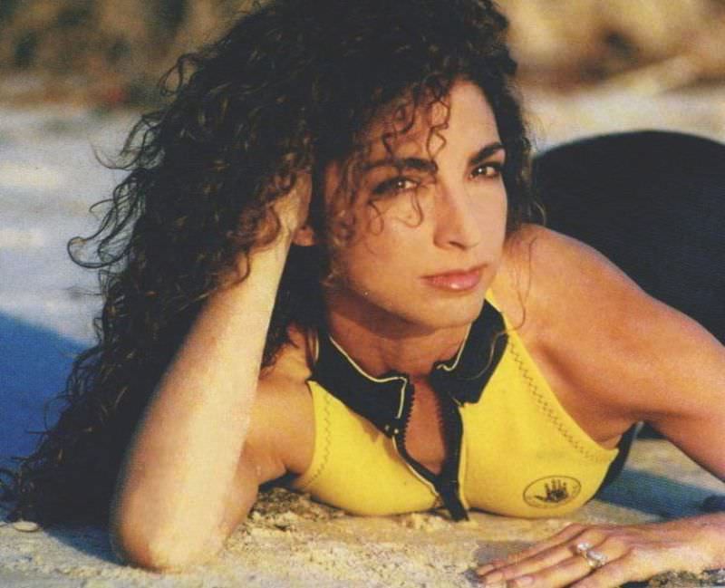 Gloria Estefan posing on the beach, 1983.