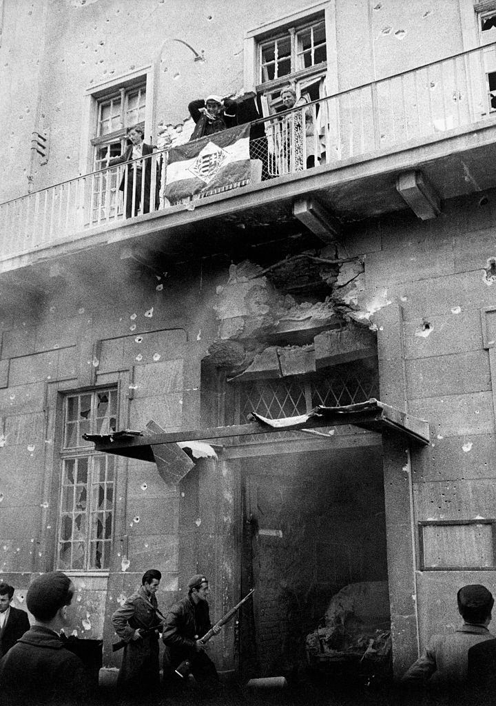 After the occupation of the headquarters of the Communist Party, on the balcony appeared the Hungarian national flag. Budapest, November 1956.