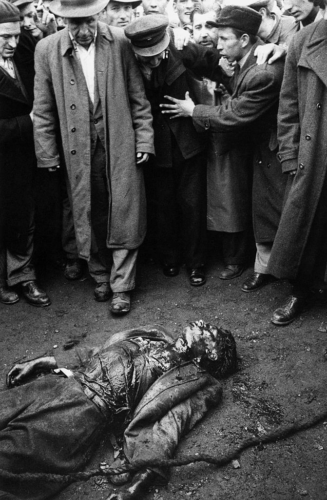 Insurgents watcing the deceased body of a colonel of the Hungarian secret police (AVH) dead during the clashes. Budapest, November 1956