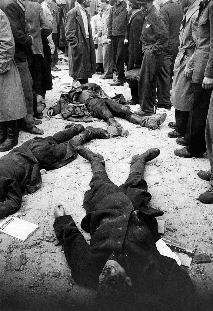 After the battle for the headquarters of the Communist Party, on the ground remain the bodies of Hungarian secret police agents (AVH).