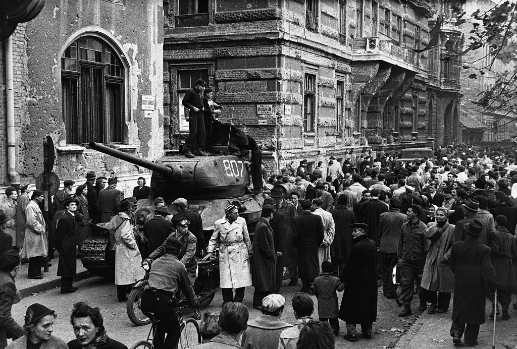 Crowds surround a captured Russian tank during the anti-Communist revolution in Hungary.