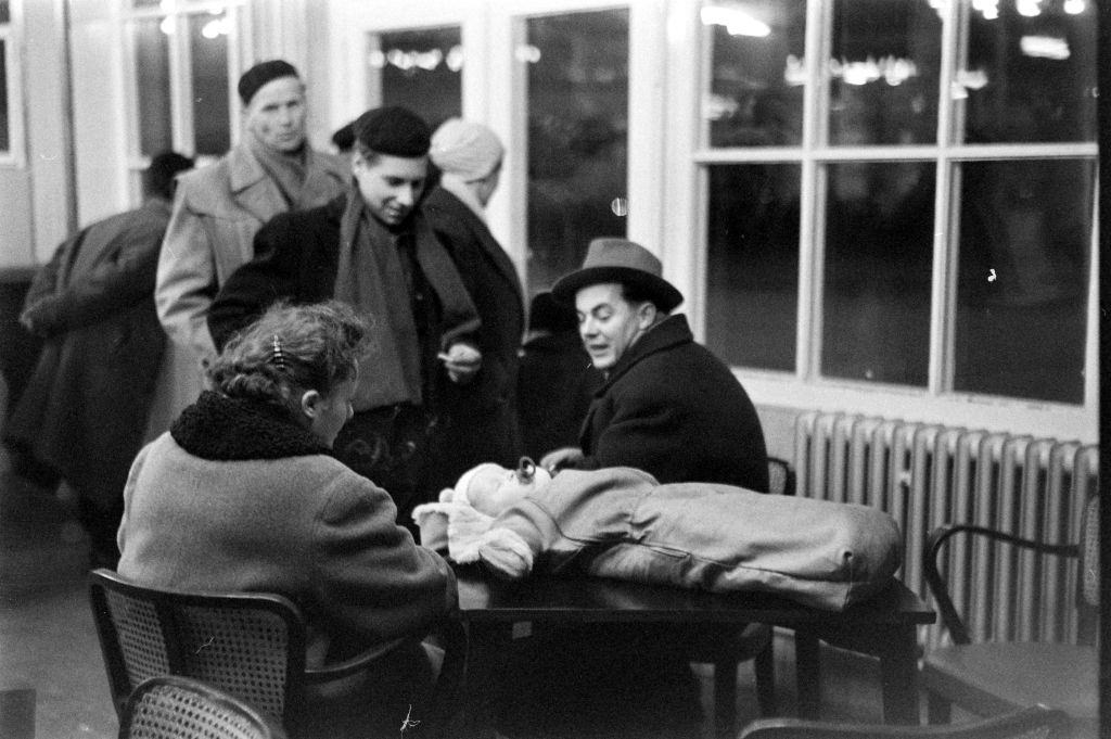 Hungarian refugees talking at the relocation during the Hungarian Revolution, Hungary, 1956.