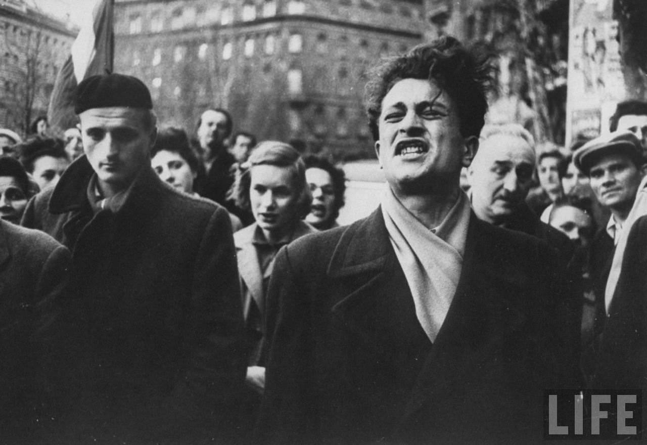 Hungarian man singing patriotic song as Soviet tanks move into Budapest during Hungarian revolution.