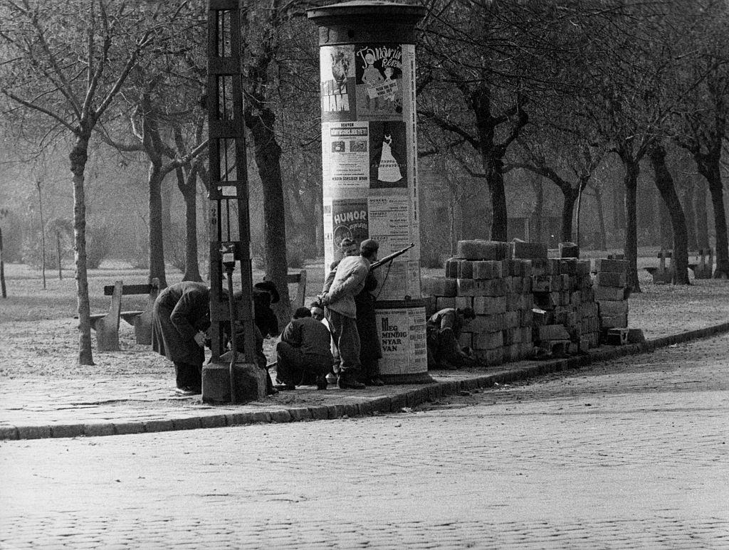 Men lying in wait at a street corner during the revolt of the Hungarian people against the Soviet tyranny. Budapest, November 1956