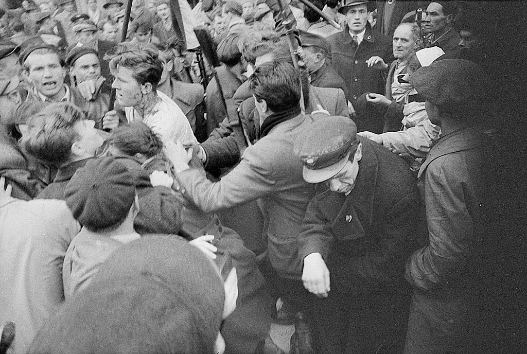 Injured officer of the Hungarian political police being caught by the rebels. Budapest, October 30, 1956.