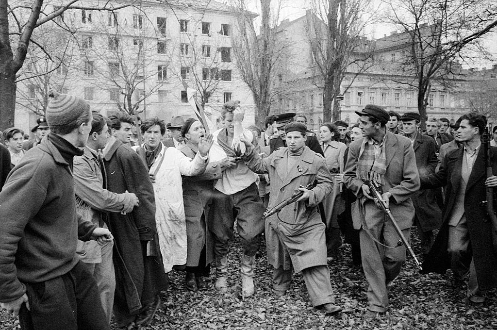 Injured officer of the Hungarian political police being caught by the rebels. Budapest, October 30, 1956.