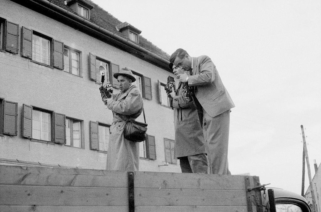 Three photographers on a van taking photos of the uprising. Budapest, 30th October 1956