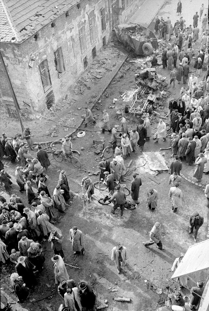 The crowd looking at the ruins after the uprising that took place in the streets of the city.