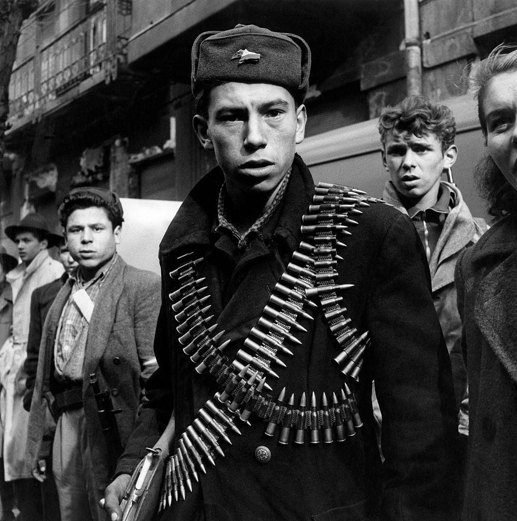 A young rebel with two cartridge belts loaded with bullets taking part in the Hungarian Revolution of 1956.