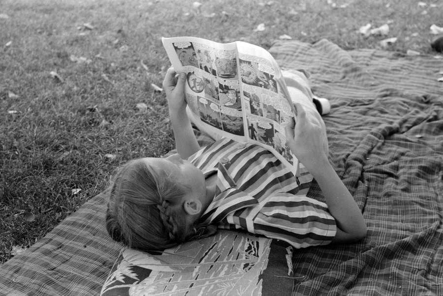 After the picnic, relaxing with a comic book.