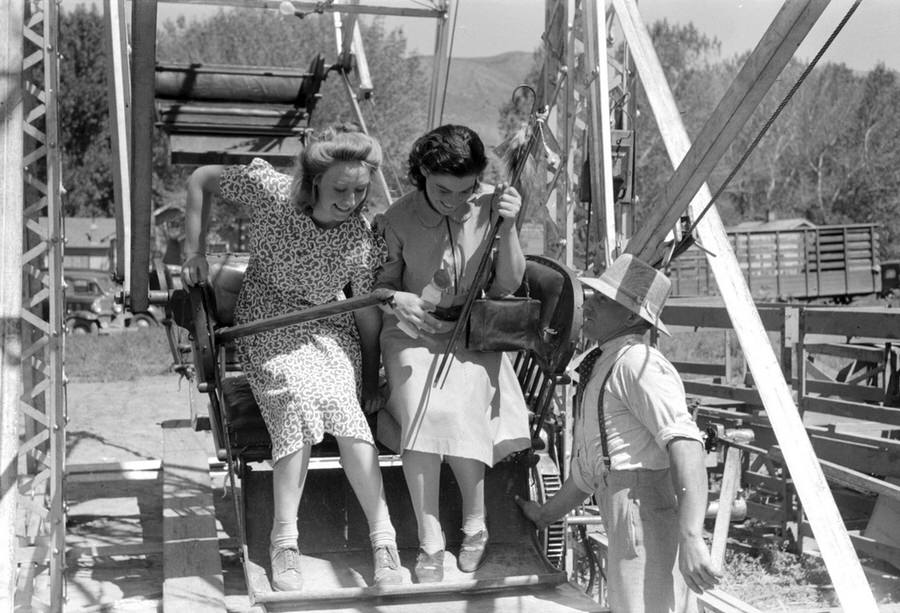 Women exit a carnival ride.