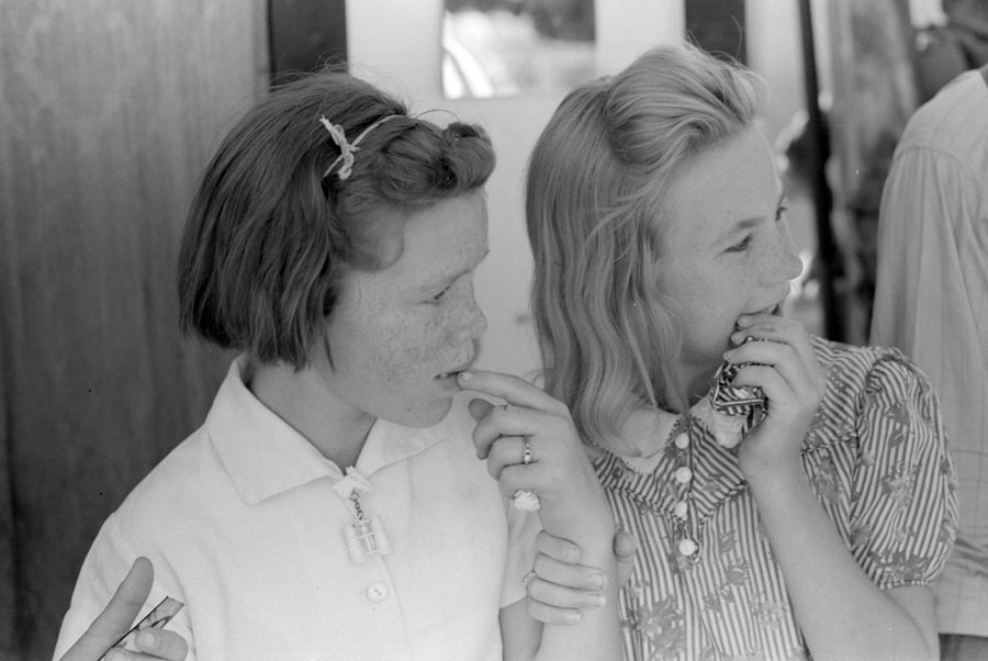 Girls watch the greased pig chase.