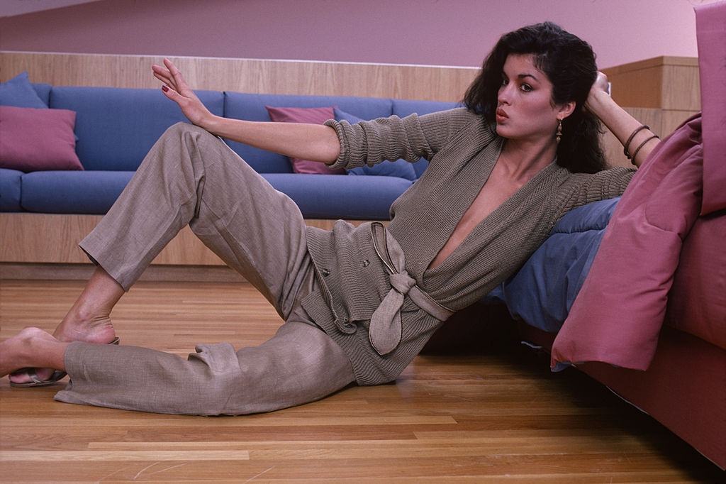 Janice Dickinson in a belted, double-breasted sweater, 1978.