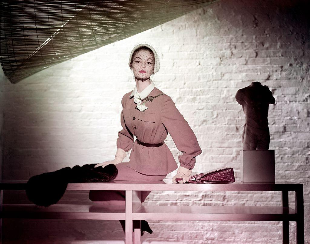 Jean Patchett in a shirt shaped jacket, straight skirt and superb glace kidskin gloves, 1950.