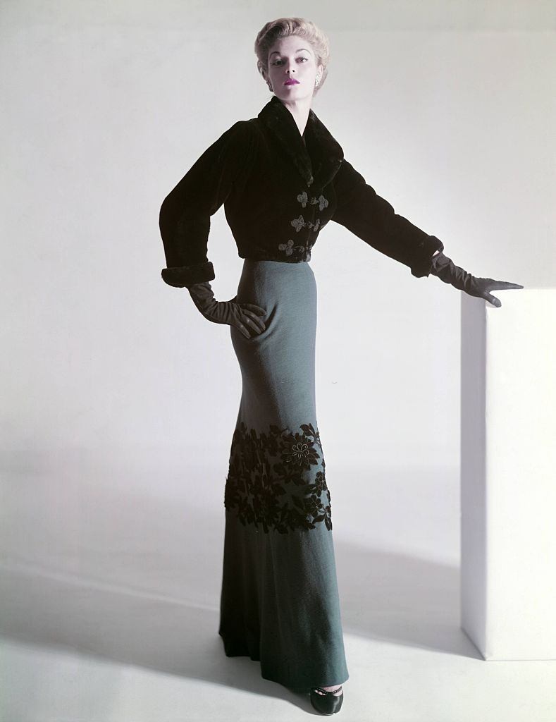 Jean Patchett in a sealskin Mainbocher jacket and floor-length skirt with velvet flowers at the knee, 1951.