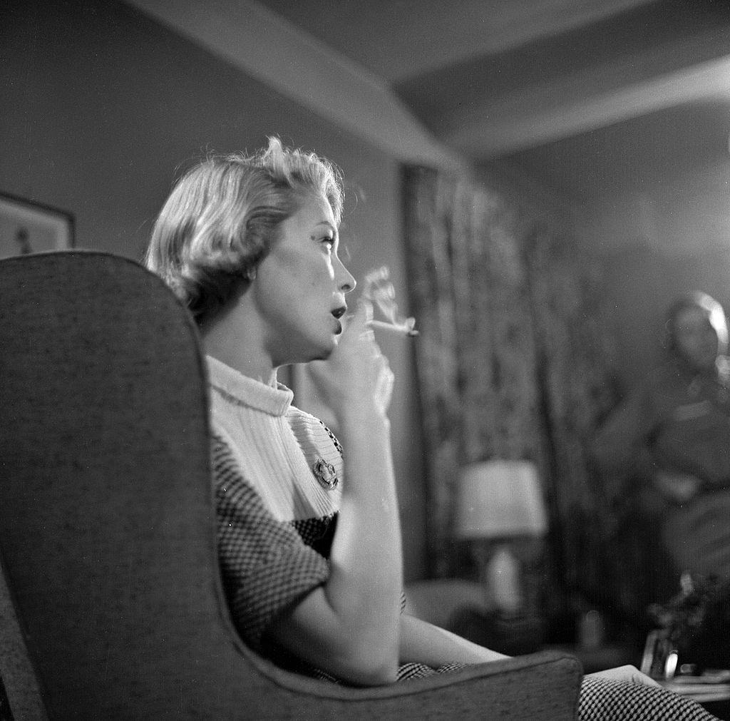 Jean Patchett smoking a cigarette at her house, 1955.