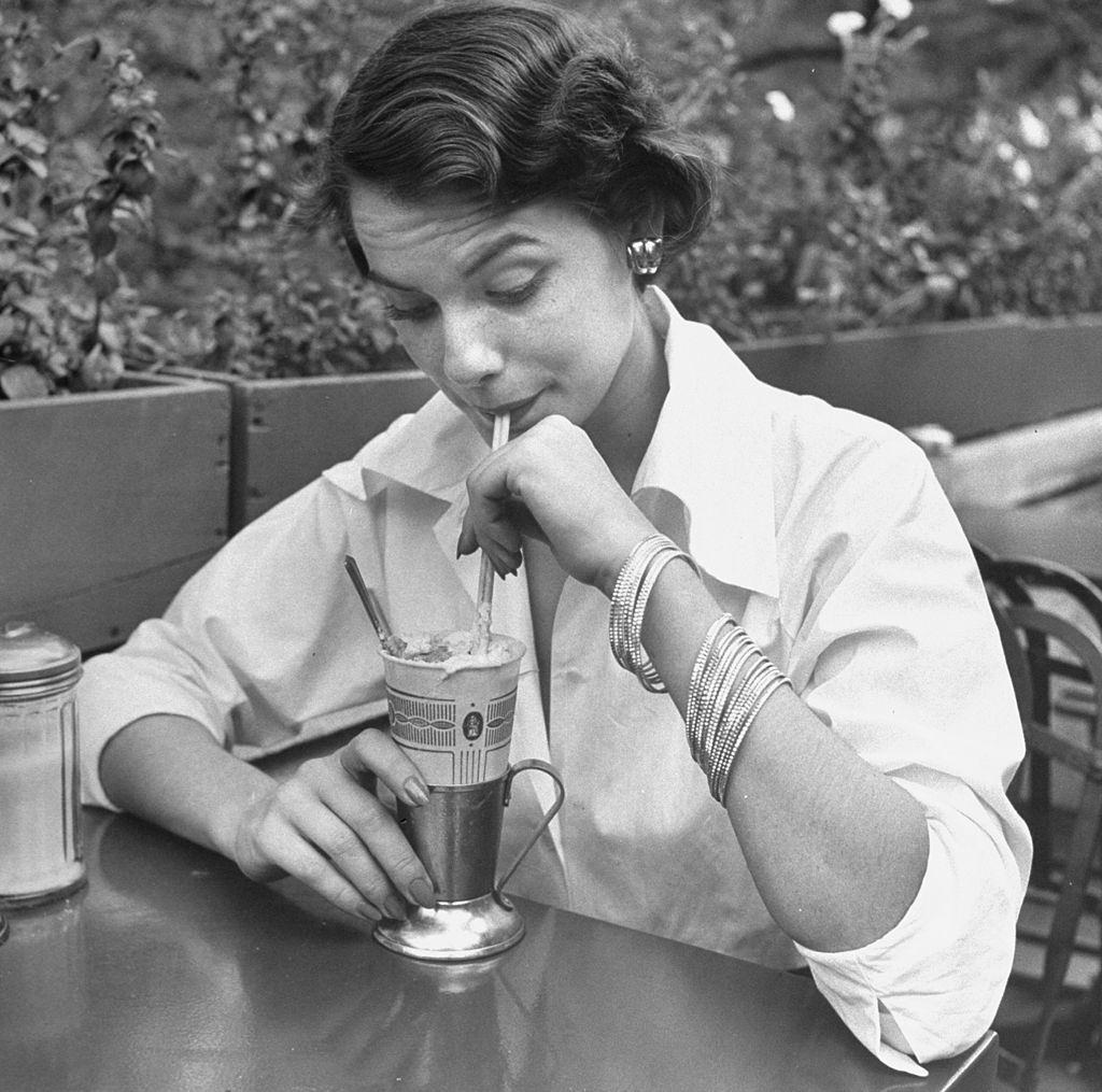 Jean Patchett modeling 20 braclets, at a nickel a piece, enlivening simple white shirt, 1949.