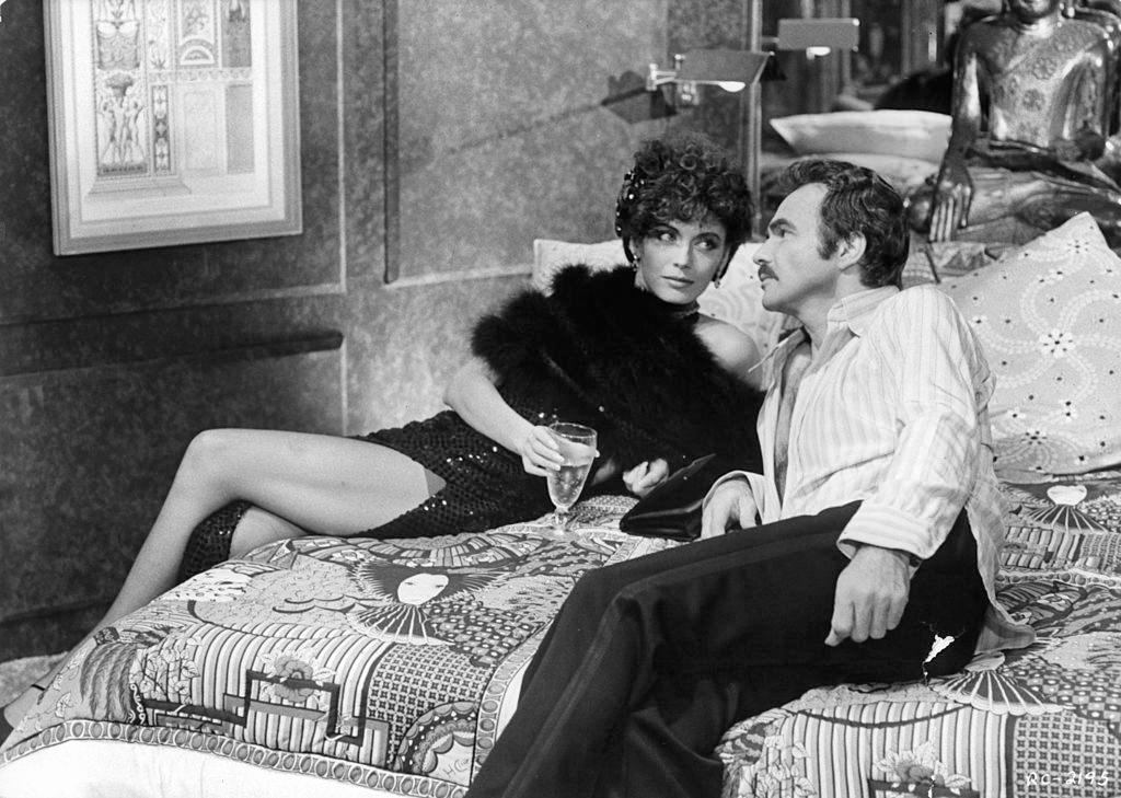 Lesley-Anne Down lies down with Burt Reynolds in a scene from the film 'Rough Cut', 1980.